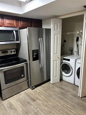 a kitchen with stainless steel appliances a stove a refrigerator and cabinets