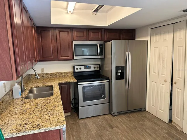 a kitchen with a sink stove and microwave