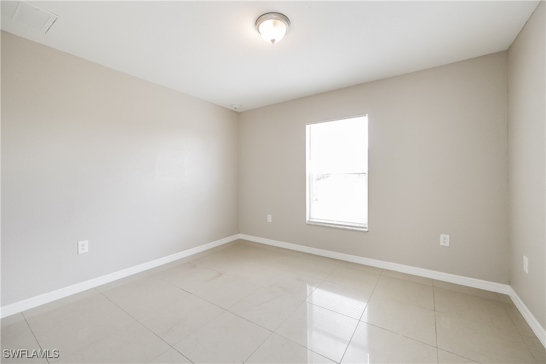 404 Willowbrook Drive Lehigh Acres, FL 33972 - Photo 12 of 16 an empty room with a window