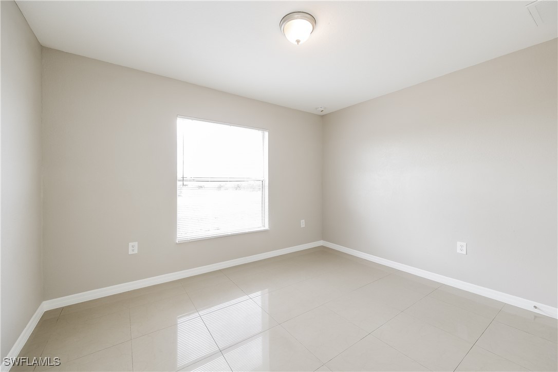 404 Willowbrook Drive Lehigh Acres, FL 33972 - Photo 13 of 16 an empty room with a window