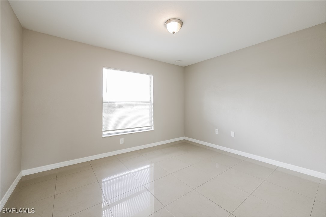 404 Willowbrook Drive Lehigh Acres, FL 33972 - Photo 14 of 16 an empty room with a window