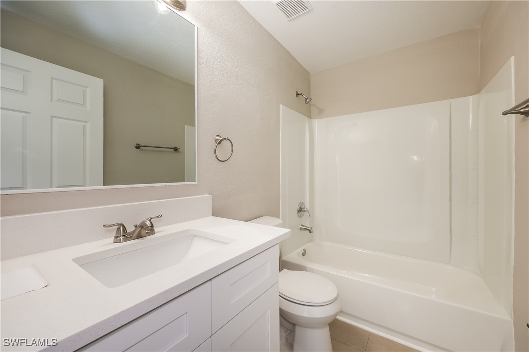 404 Willowbrook Drive Lehigh Acres, FL 33972 - Photo 15 of 16 a bathroom with a sink a toilet and a bathtub
