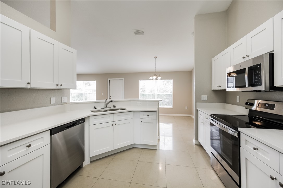 404 Willowbrook Drive Lehigh Acres, FL 33972 - Photo 7 of 16 a kitchen with a sink stove top oven and cabinets