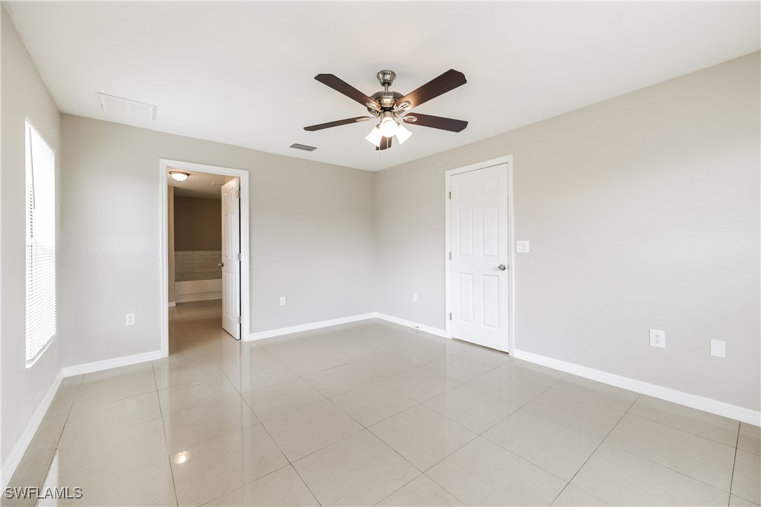 404 Willowbrook Drive Lehigh Acres, FL 33972 - Photo 10 of 16 an empty room with closet and a ceiling fan