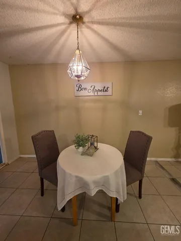 a view of a dining room with furniture and chandelier