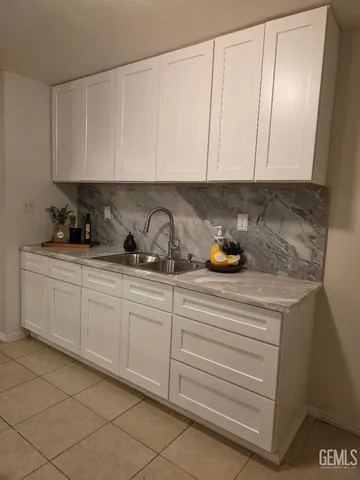 a kitchen with a sink and cabinets