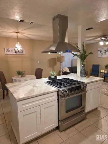 a kitchen with a stove and cabinets