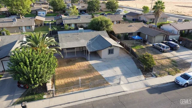 an aerial view of a house with a yard and potted plants