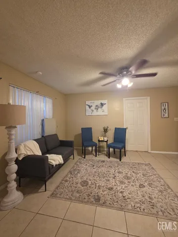 a living room with furniture and a dining table