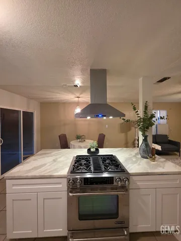 a stove top oven sitting inside of a kitchen