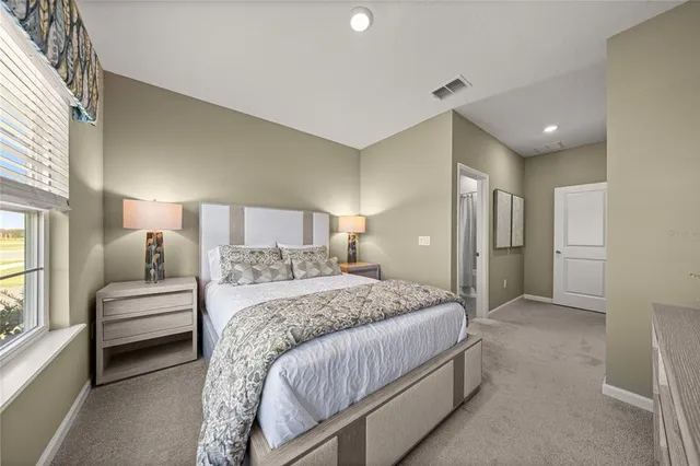 a spacious bedroom with a bed and a couch