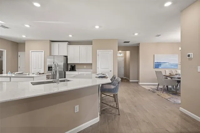 a large kitchen with a table and chairs in it