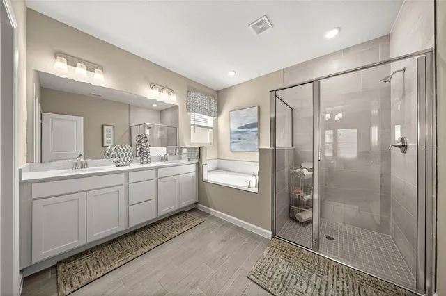 a bathroom with a shower sink and mirror