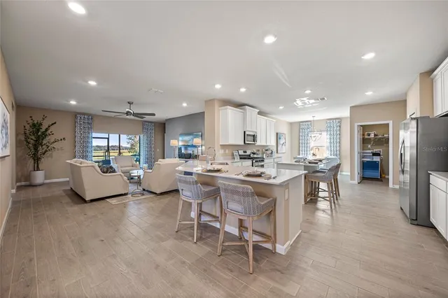 a large kitchen with a table and chairs