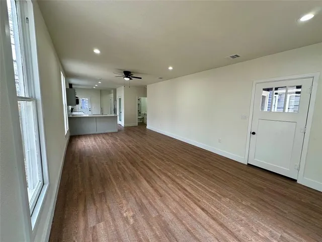 a kitchen with stainless steel appliances a sink a stove top oven a window and a counter space