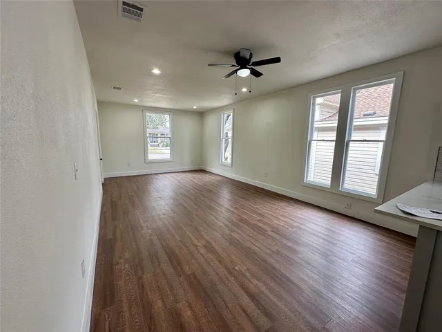 a kitchen with a sink a microwave and wooden floor
