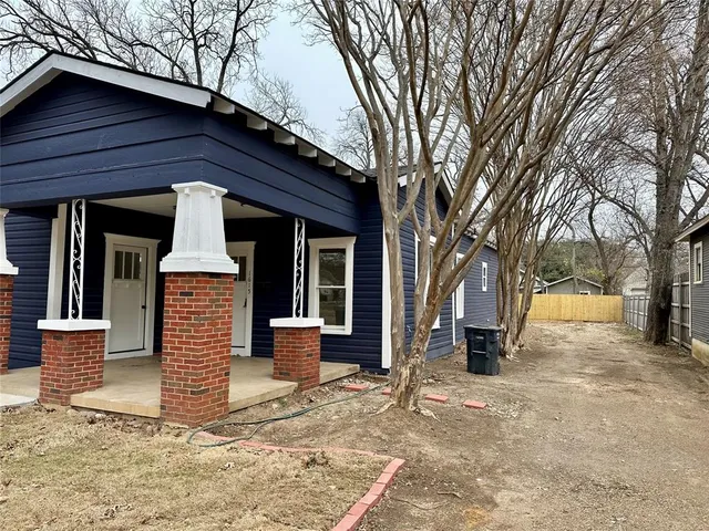 a front view of a house with a yard covered in snow