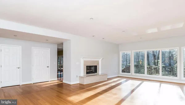 a dining room with furniture a fireplace and wooden floor
