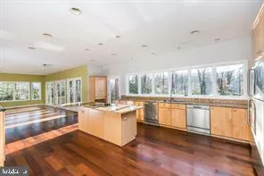 a view of a livingroom with wooden floor and furniture