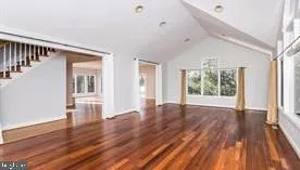 a large kitchen with kitchen island granite countertop a sink and a stove top oven