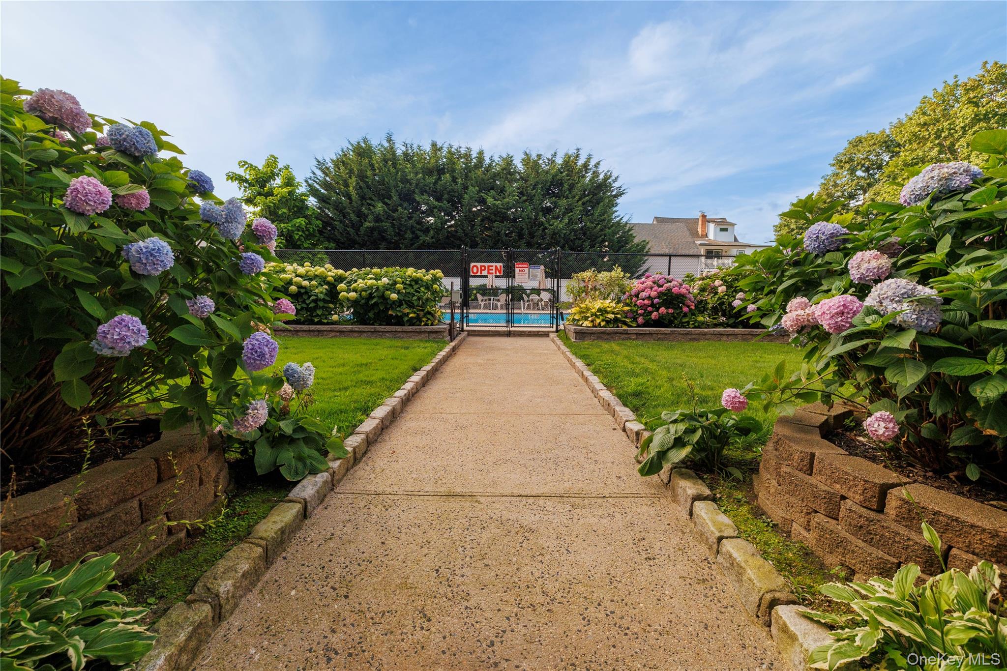 250 West Merrick Road, Unit 1E Freeport, NY 11520 - Photo 18 of 23 Entrance to community pool.