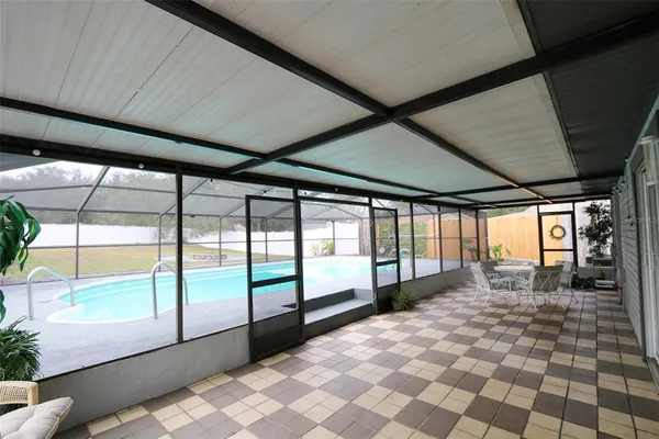 a dining room with furniture a chandelier and wooden floor