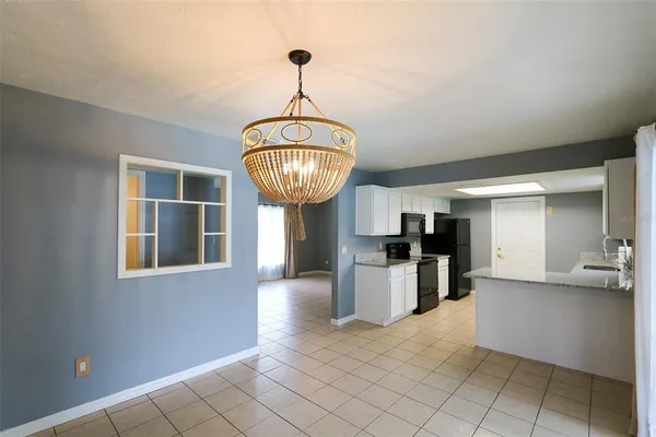 a view of a kitchen center island and stainless steel appliances