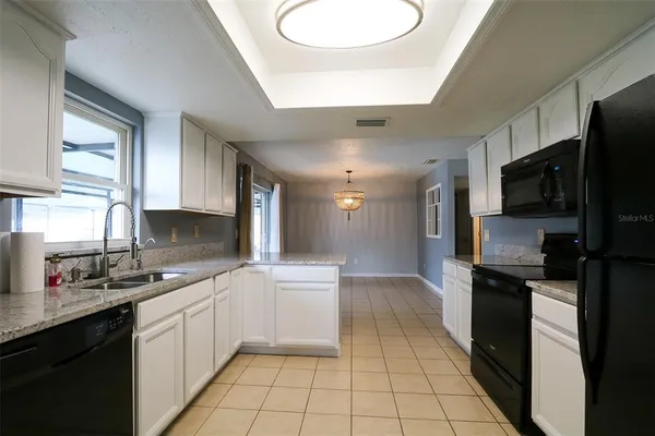 a kitchen with a refrigerator and a stove top oven