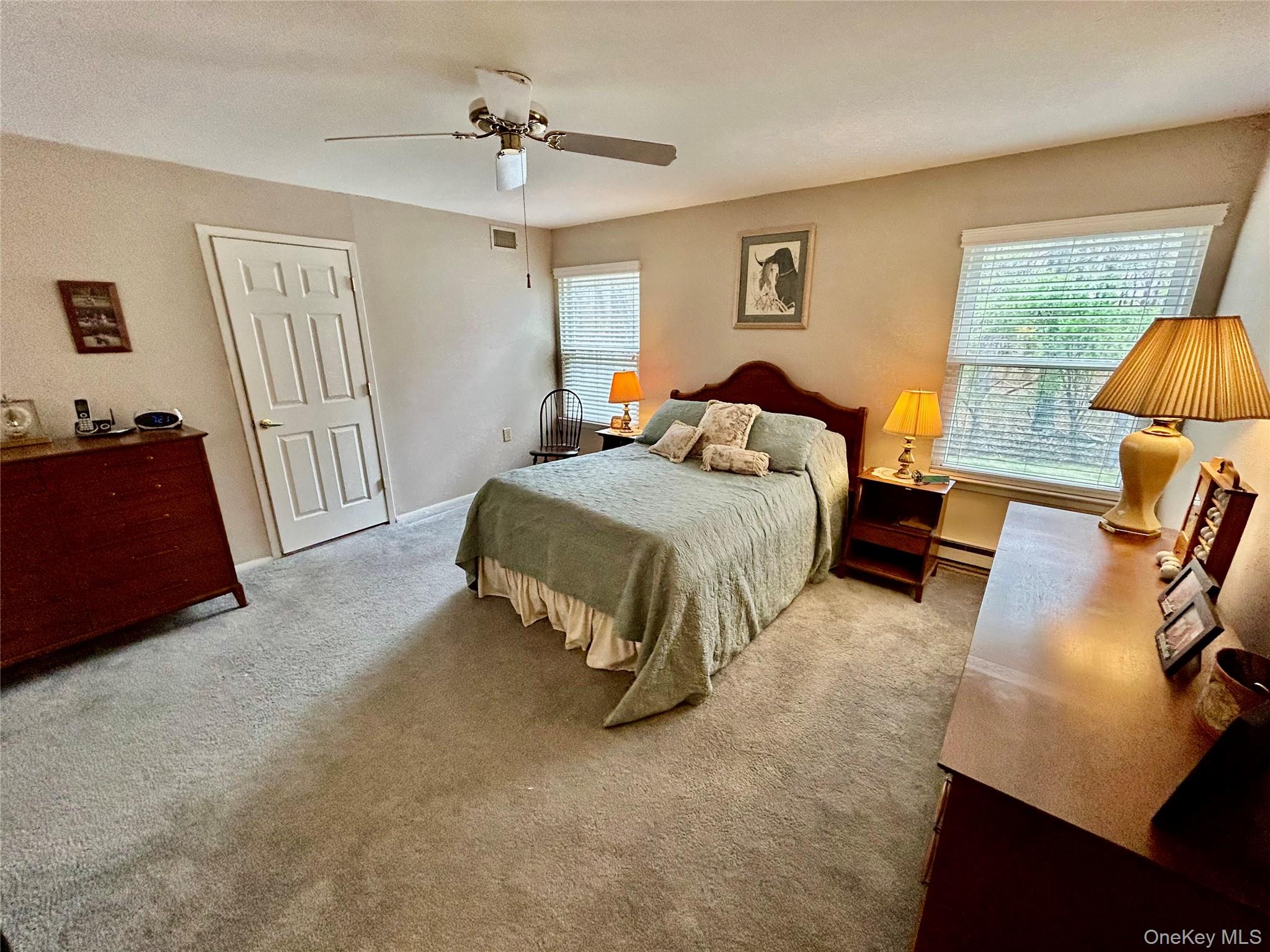 520 Cranston Lane Ridge, NY 11961 - Photo 13 of 18 Primary bedroom with primary bathroom and walk in closet.