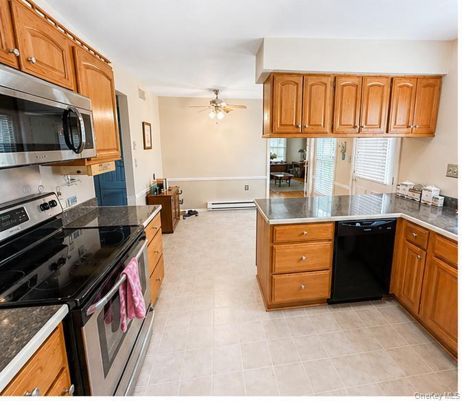 520 Cranston Lane Ridge, NY 11961 - Photo 8 of 18 Kitchen with wood cabinets, Newer appliances, entry to side yard