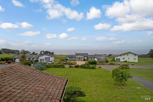 a view of an ocean yard and mountain view in back