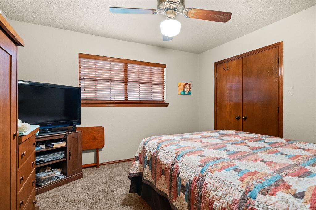 5840 Crystal Drive Midlothian, TX 76065 - Photo 15 of 36 a bedroom with a bed and a flat screen tv