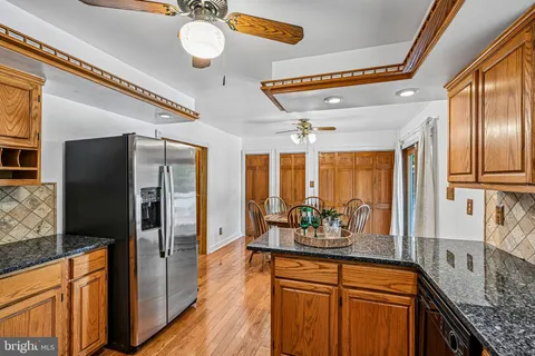 a kitchen with granite countertop a refrigerator and a sink