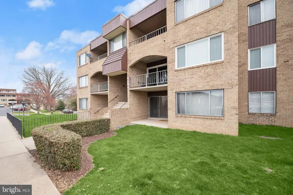 a front view of a house with a garden and yard