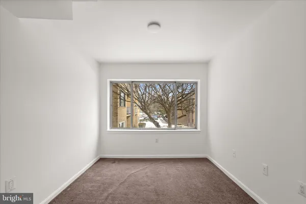 a large white kitchen with a stove top oven a sink and dishwasher
