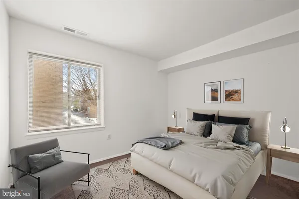 a bedroom with a bed and a couch