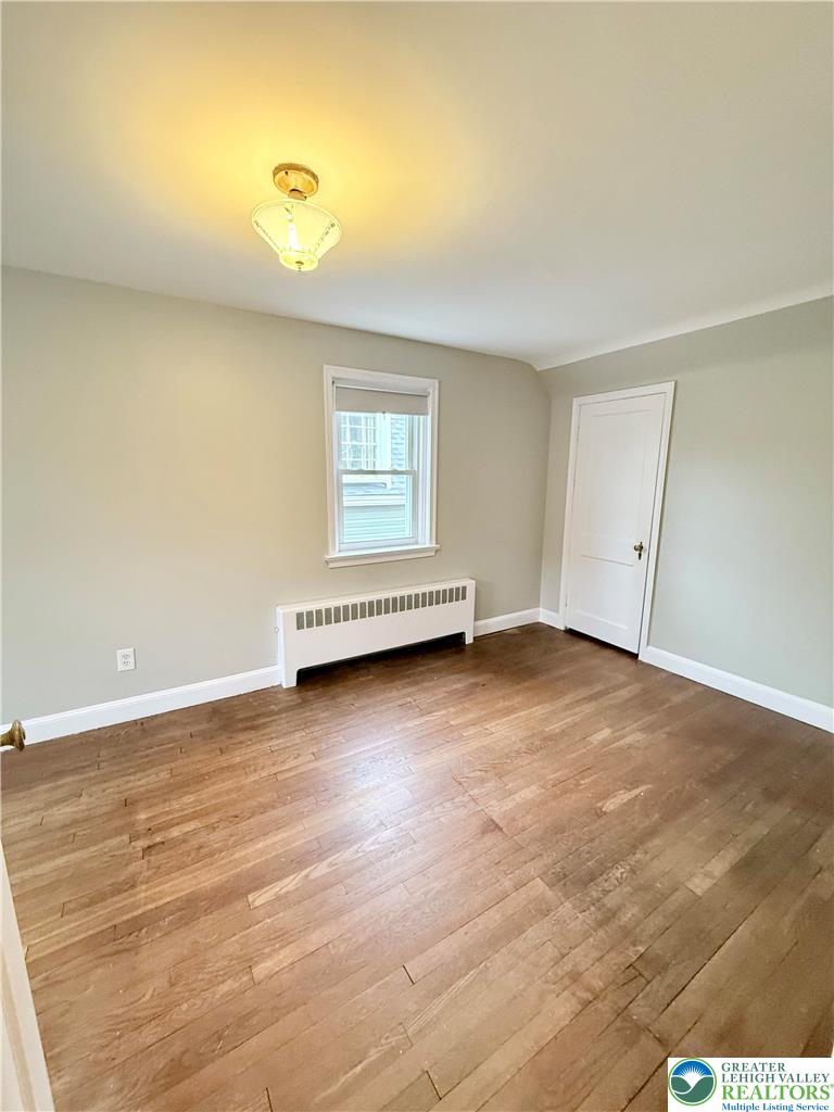 2109 Kemmerer Street Bethlehem, PA 18017 - Photo 22 of 41 a view of an empty room with wooden floor and a window