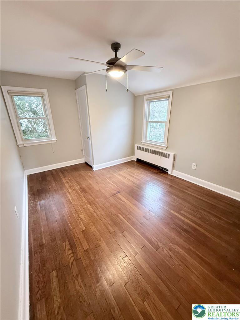 2109 Kemmerer Street Bethlehem, PA 18017 - Photo 26 of 41 an empty room with wooden floor chandelier fan and windows