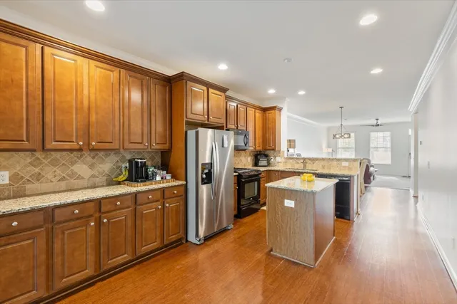 a kitchen with refrigerator cabinets and wooden floor