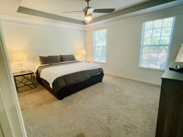 a spacious bedroom with a bed and a window