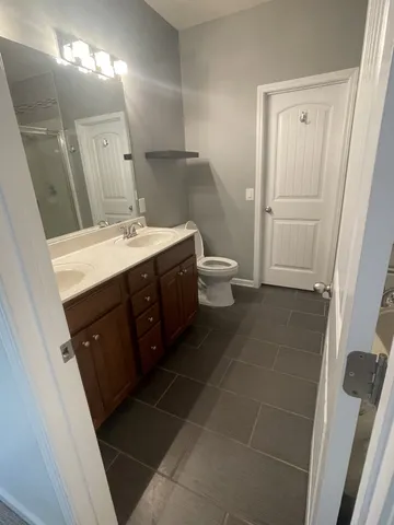 a spacious bathroom with a bathtub sink vanity and a toilet