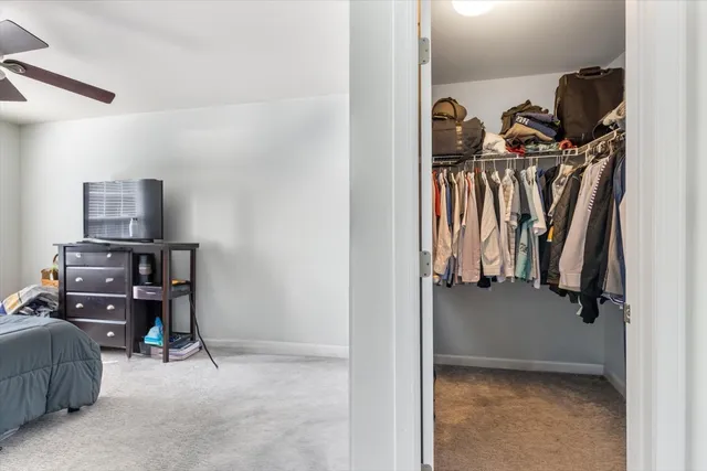 a view of walk in closet with clothes