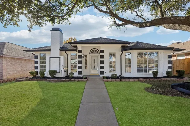 a view of a large garden with large windows and a big yard
