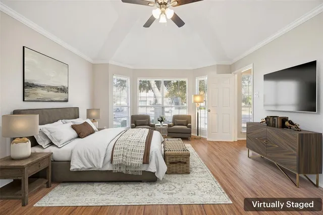 a bedroom with a bed and a flat tv screen