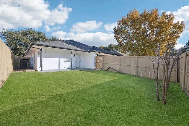 a view of a backyard with large trees