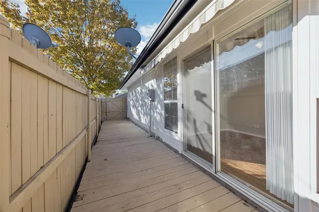 a view of a balcony with wooden floor