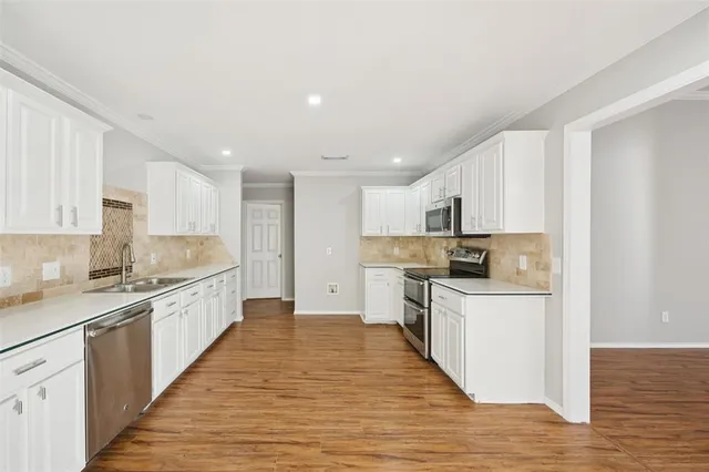 a large kitchen with stainless steel appliances granite countertop a large center island and a sink