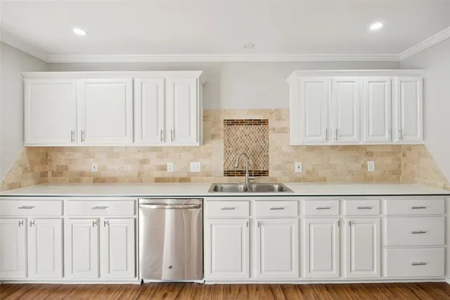 a kitchen with granite countertop white cabinets and sink