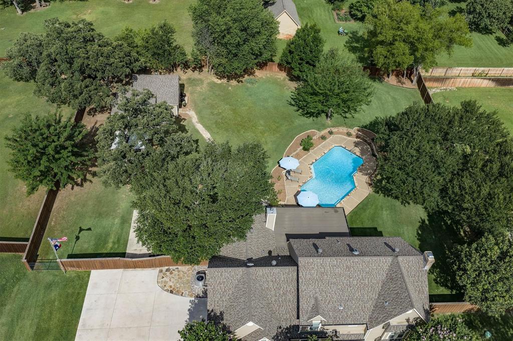 410 Simmons Road Double Oak, TX 75077 - Photo 4 of 40 Overhead view highlighting the pool, expansive yard, and home's layout.