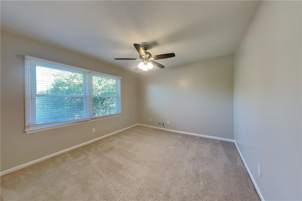 1916 Beckett Drive Marietta, GA 30062 - Photo 11 of 20 an empty room with a window and a ceiling fan